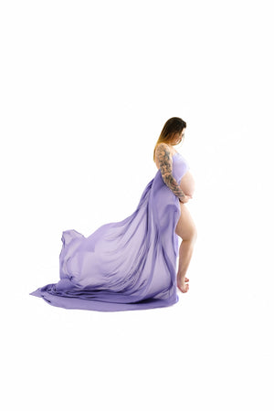 Pregnant individual posing for Nuovo’s Life collection on a white backdrop